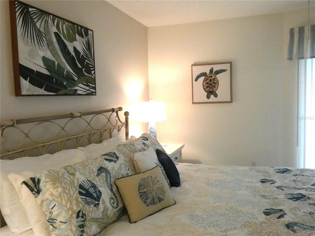 9300 Clubside Circle, Unit 1307 Sarasota, FL 34238 - Photo 14 of 40 a bedroom with a bed and painting on the wall