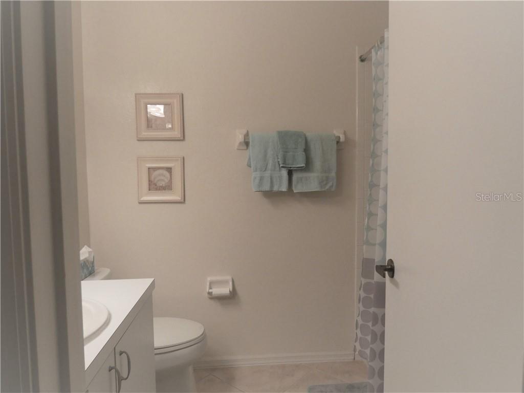 9300 Clubside Circle, Unit 1307 Sarasota, FL 34238 - Photo 19 of 40 a bathroom with a toilet and a shower