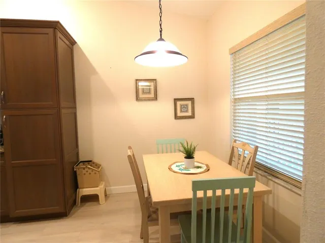 a dining room with furniture and window