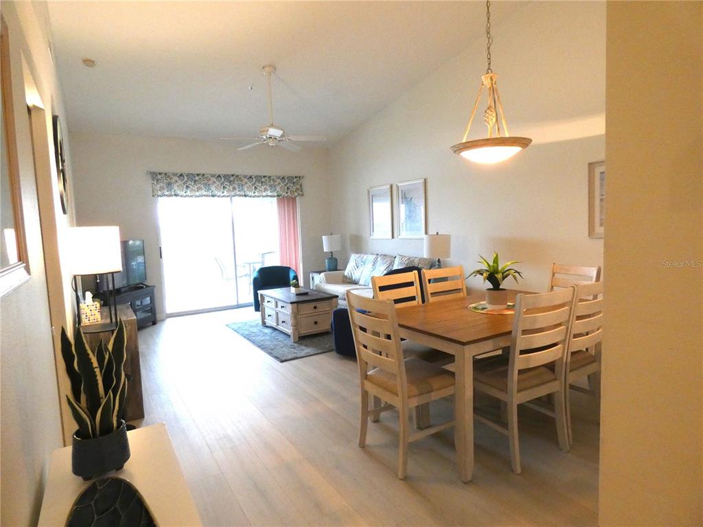 9300 Clubside Circle, Unit 1307 Sarasota, FL 34238 - Photo 6 of 40 a dining room with furniture and a chandelier