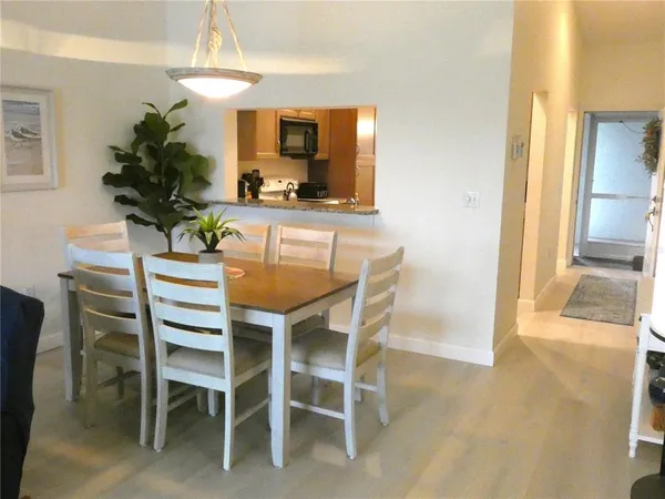 a dining room with furniture and a chandelier