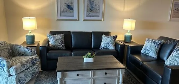 a living room with furniture and a lamp