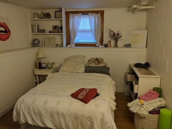 a bedroom with a bed and a window