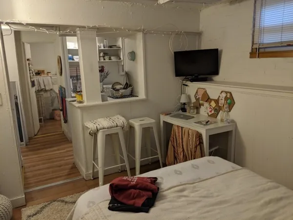 a bedroom with a bed and a flat screen tv