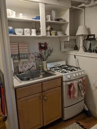 a kitchen with stainless steel appliances granite countertop a sink stove and cabinets