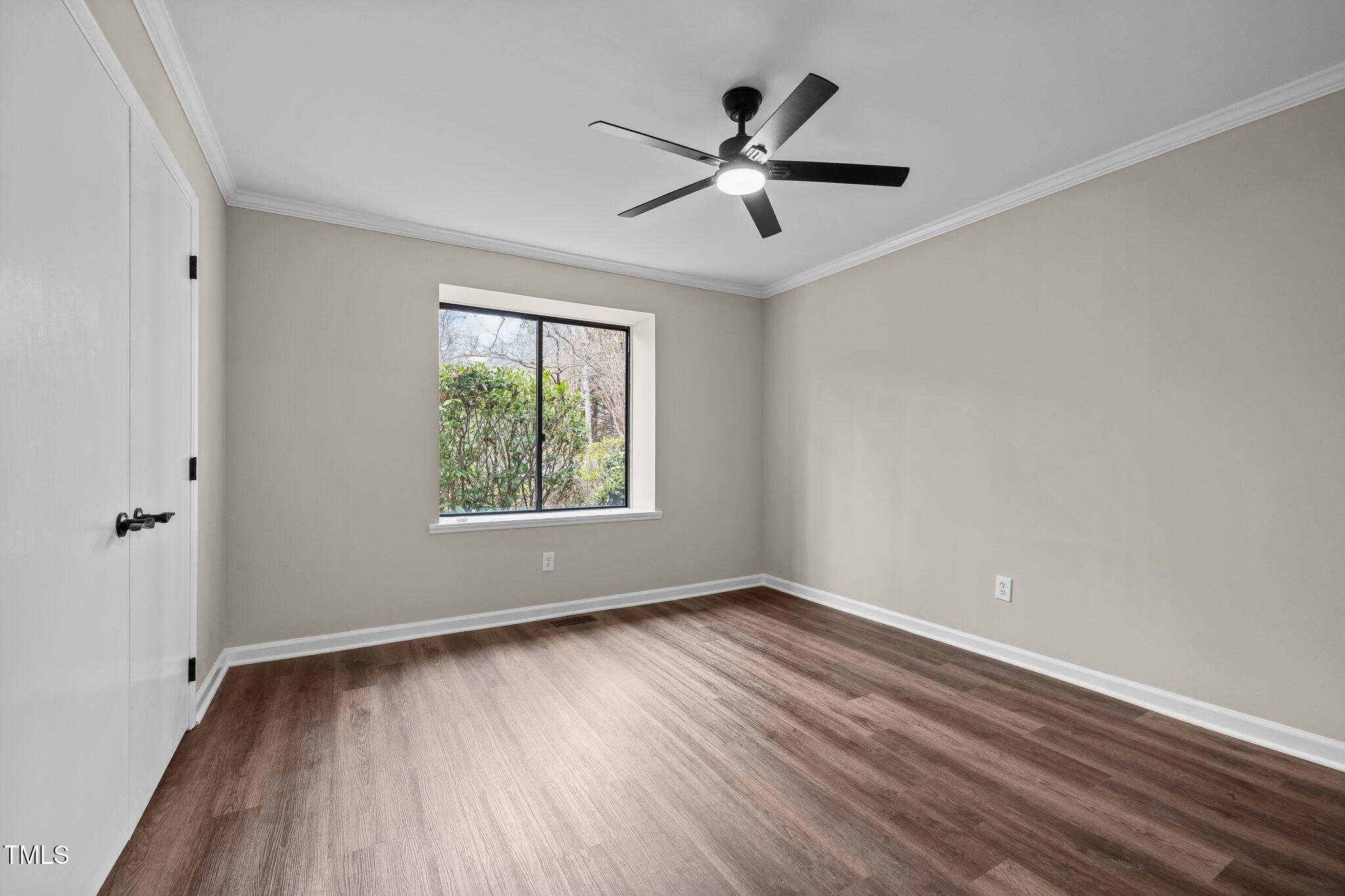 5850 Branchwood Road Raleigh, NC 27609 - Photo 17 of 27 wooden floor in an empty room with a window