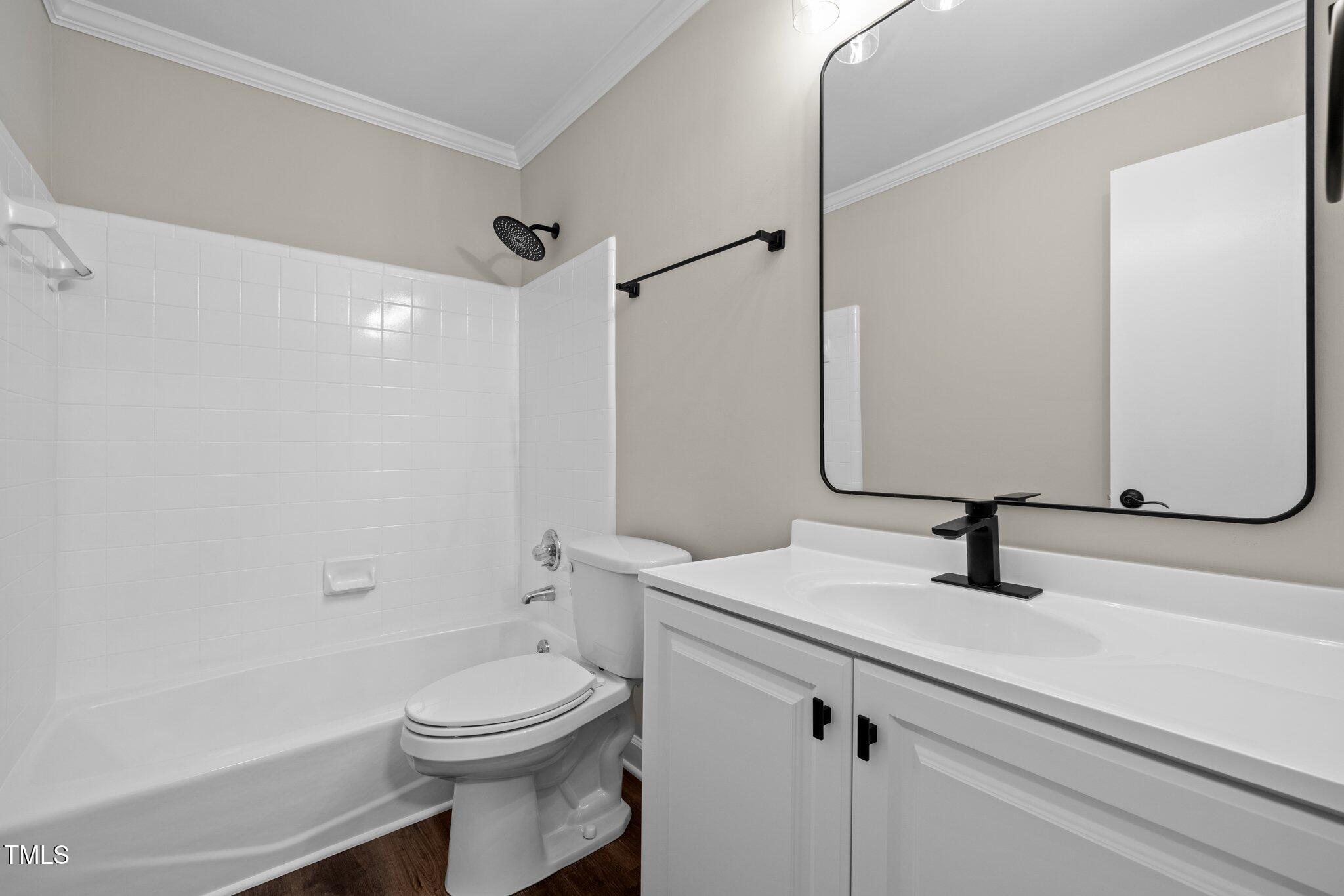 5850 Branchwood Road Raleigh, NC 27609 - Photo 19 of 27 a bathroom with a sink a toilet and shower