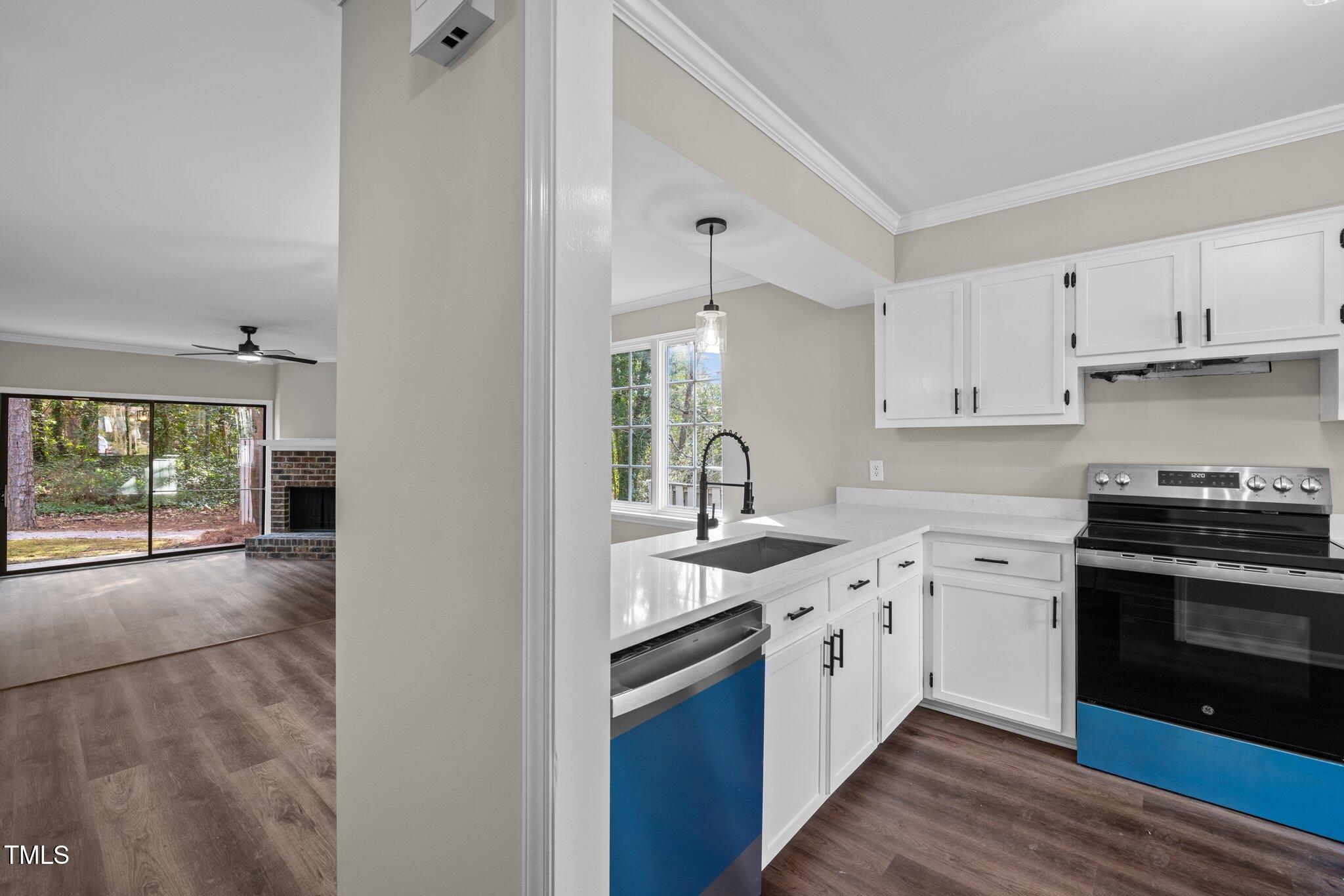 5850 Branchwood Road Raleigh, NC 27609 - Photo 3 of 27 a kitchen with stainless steel appliances granite countertop a stove sink and cabinets