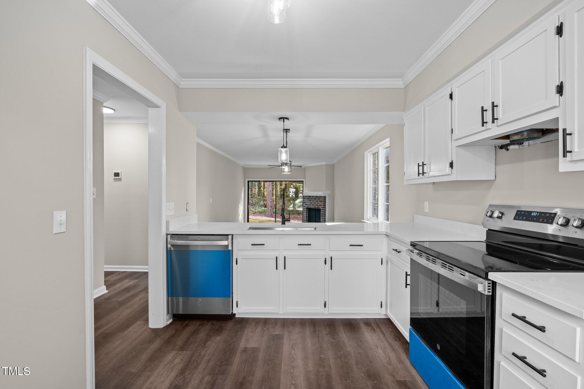 5850 Branchwood Road Raleigh, NC 27609 - Photo 5 of 27 a kitchen with granite countertop a stove and white cabinets