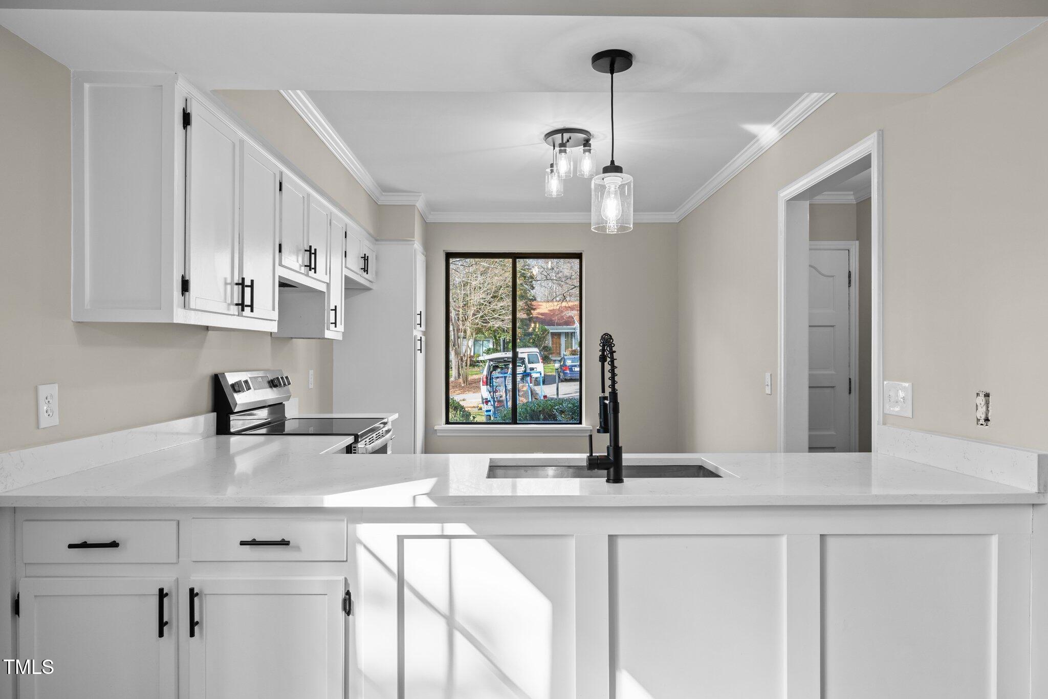 5850 Branchwood Road Raleigh, NC 27609 - Photo 6 of 27 a kitchen with stainless steel appliances a sink stove and cabinets