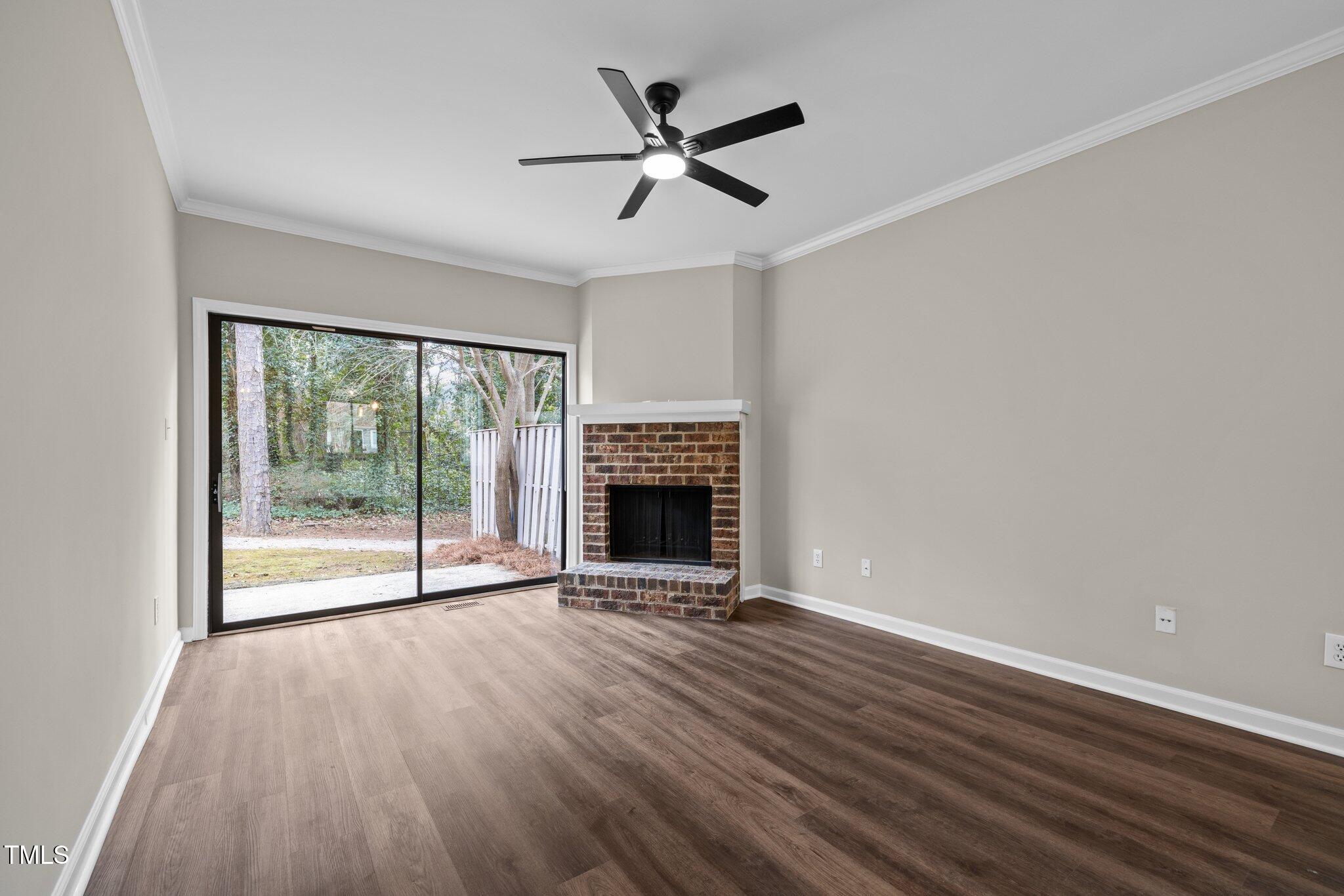 5850 Branchwood Road Raleigh, NC 27609 - Photo 10 of 27 wooden floor fireplace and natural light in room