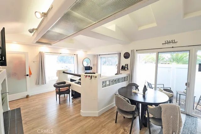 a dining room with furniture and wooden floor