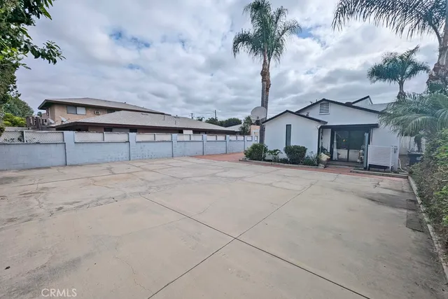 a aerial view of a house with a yard and potted plants