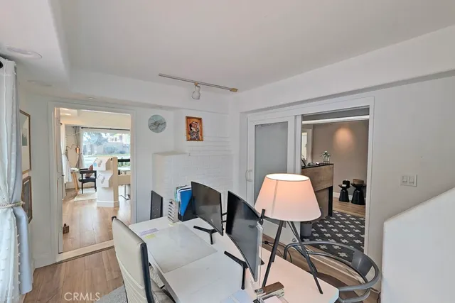 a view of a dining room with furniture large windows and wooden floor