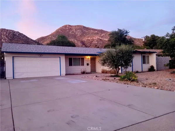 a front view of house with a yard and a garage