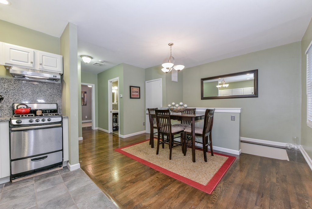 253 Gold Street, Unit 1 Boston, MA 02127 - Photo 1 of 19 a view of a dining room with furniture and wooden floor