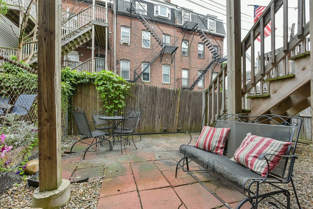 253 Gold Street, Unit 1 Boston, MA 02127 - Photo 16 of 19 a view of a patio with couches table and chairs and potted plants
