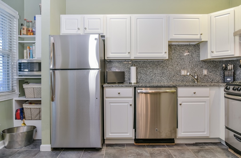 253 Gold Street, Unit 1 Boston, MA 02127 - Photo 6 of 19 a white refrigerator freezer sitting inside of a kitchen