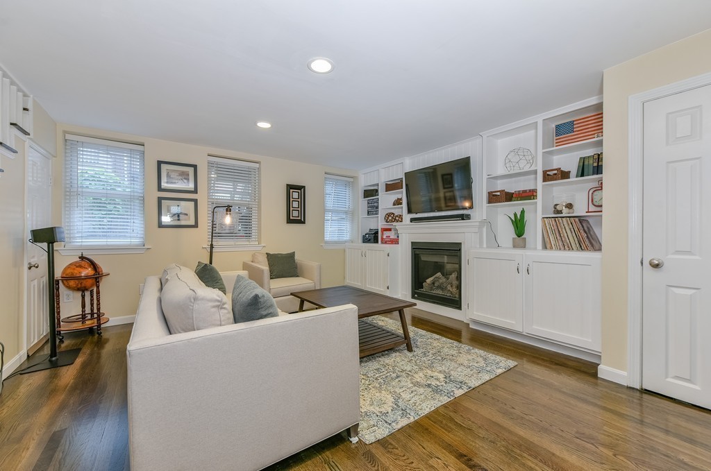 253 Gold Street, Unit 1 Boston, MA 02127 - Photo 7 of 19 a living room with furniture a flat screen tv and a fireplace