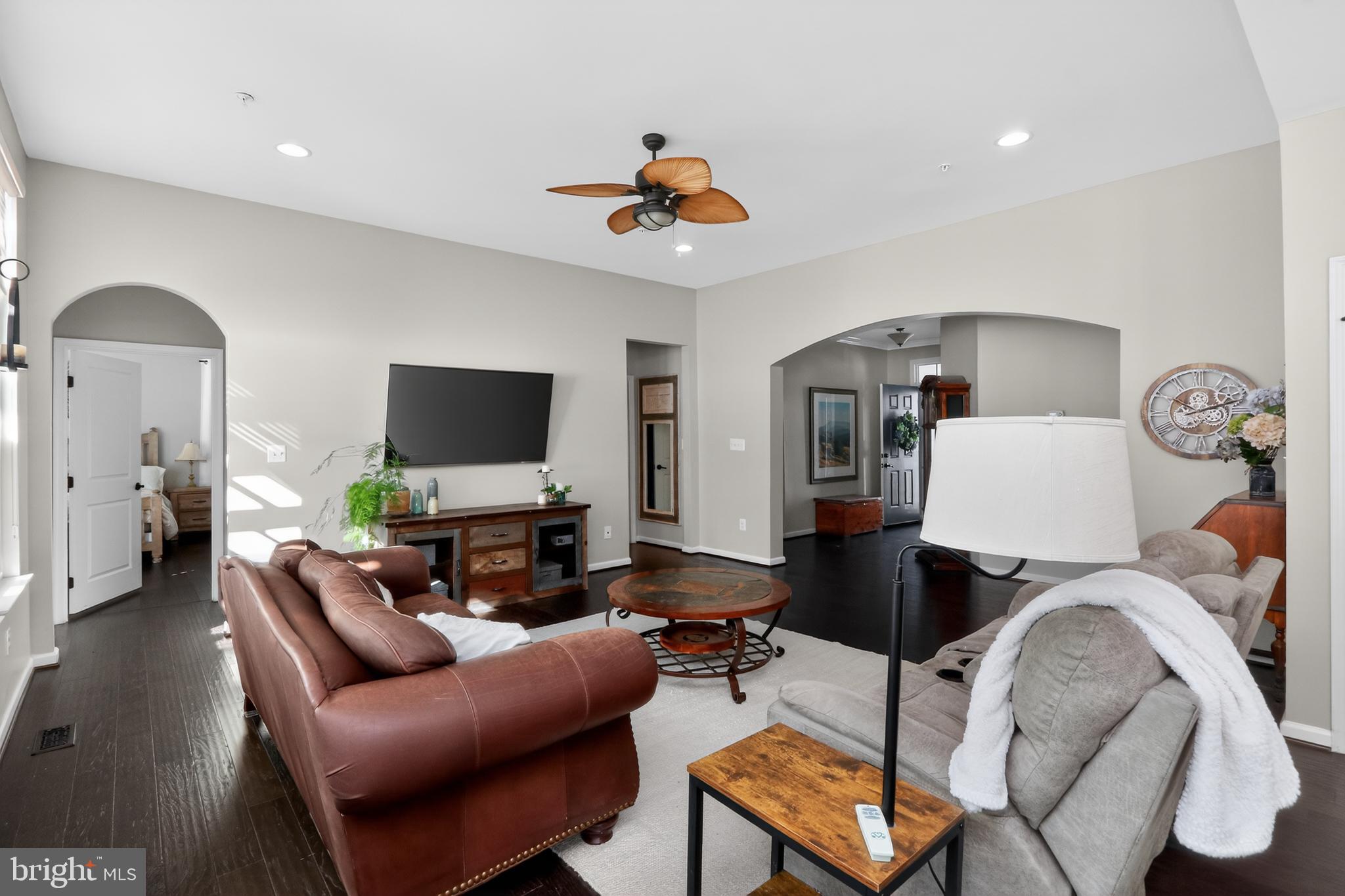 17518 Spring Cress Drive Dumfries, VA 22026 - Photo 19 of 89 a living room with furniture a flat screen tv and kitchen view