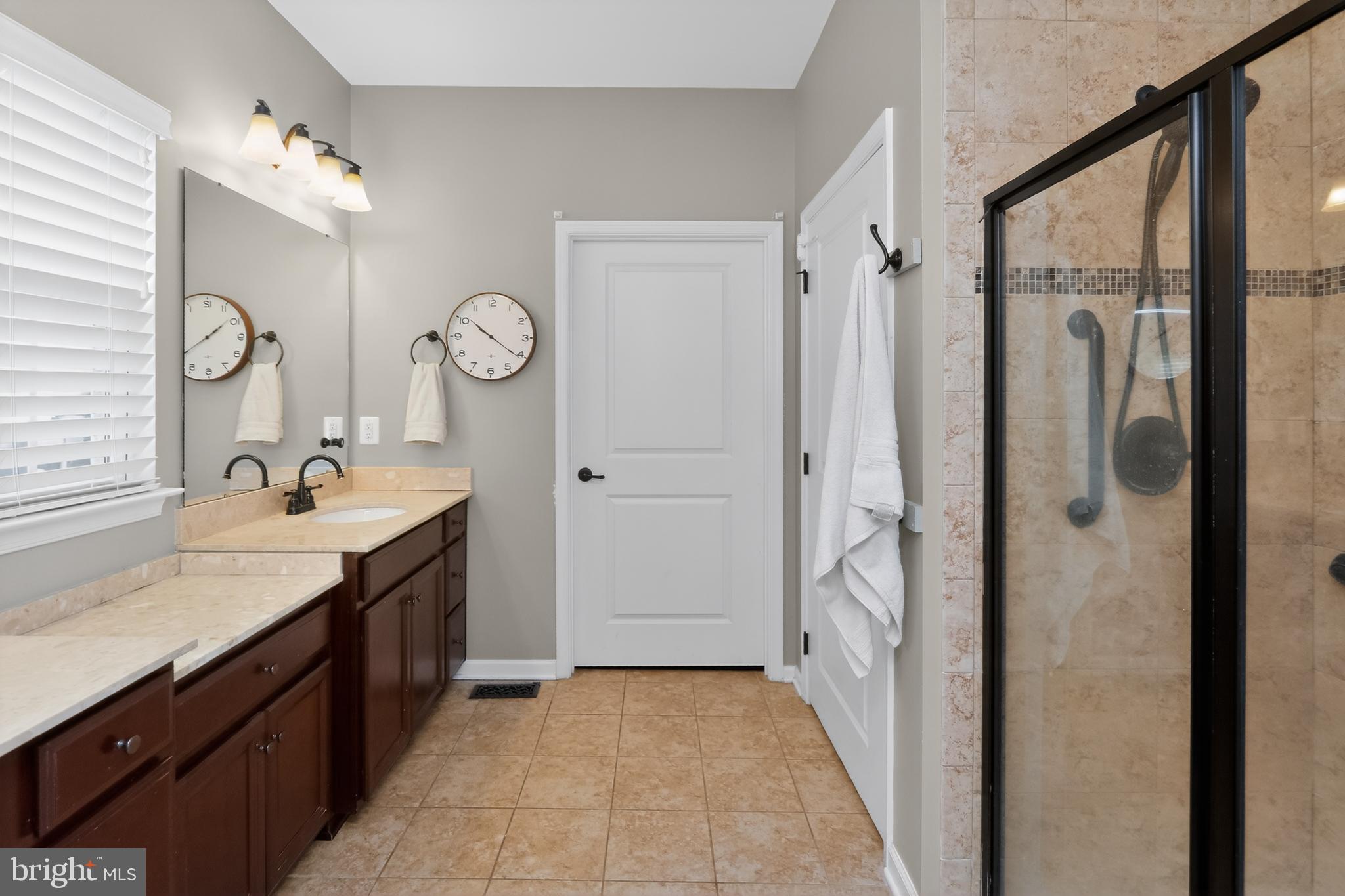 17518 Spring Cress Drive Dumfries, VA 22026 - Photo 19 of 37 a bathroom with a double vanity sink mirror and shower
