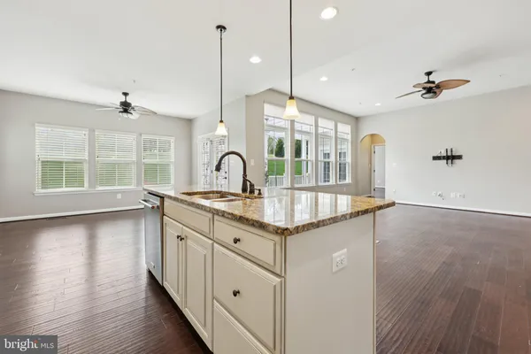 a view of walk in closet with wooden floor and windows