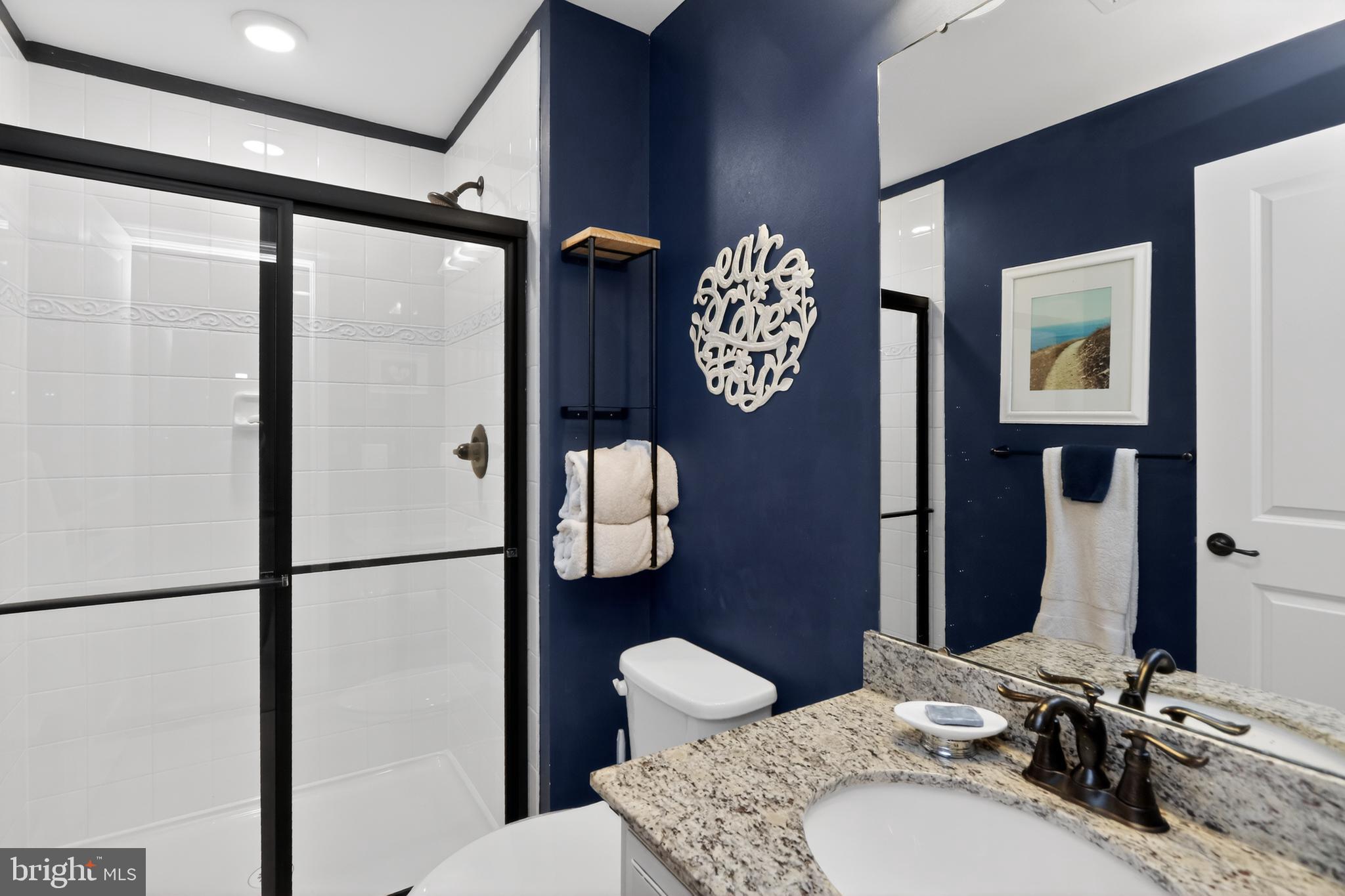 17518 Spring Cress Drive Dumfries, VA 22026 - Photo 27 of 37 a bathroom with a granite countertop sink mirror vanity and toilet