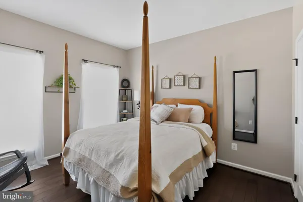 an empty room with wooden floor and white wall