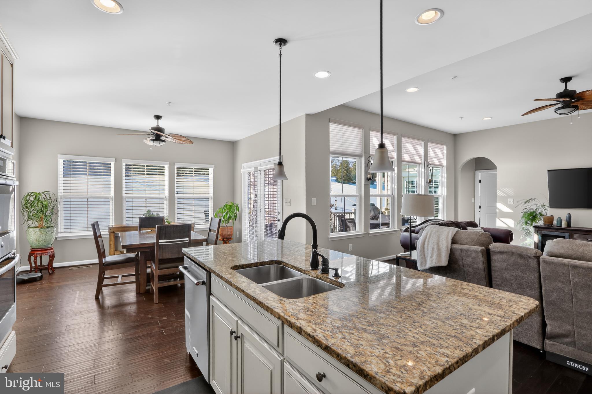 17518 Spring Cress Drive Dumfries, VA 22026 - Photo 3 of 37 a kitchen with granite countertop a table and chairs