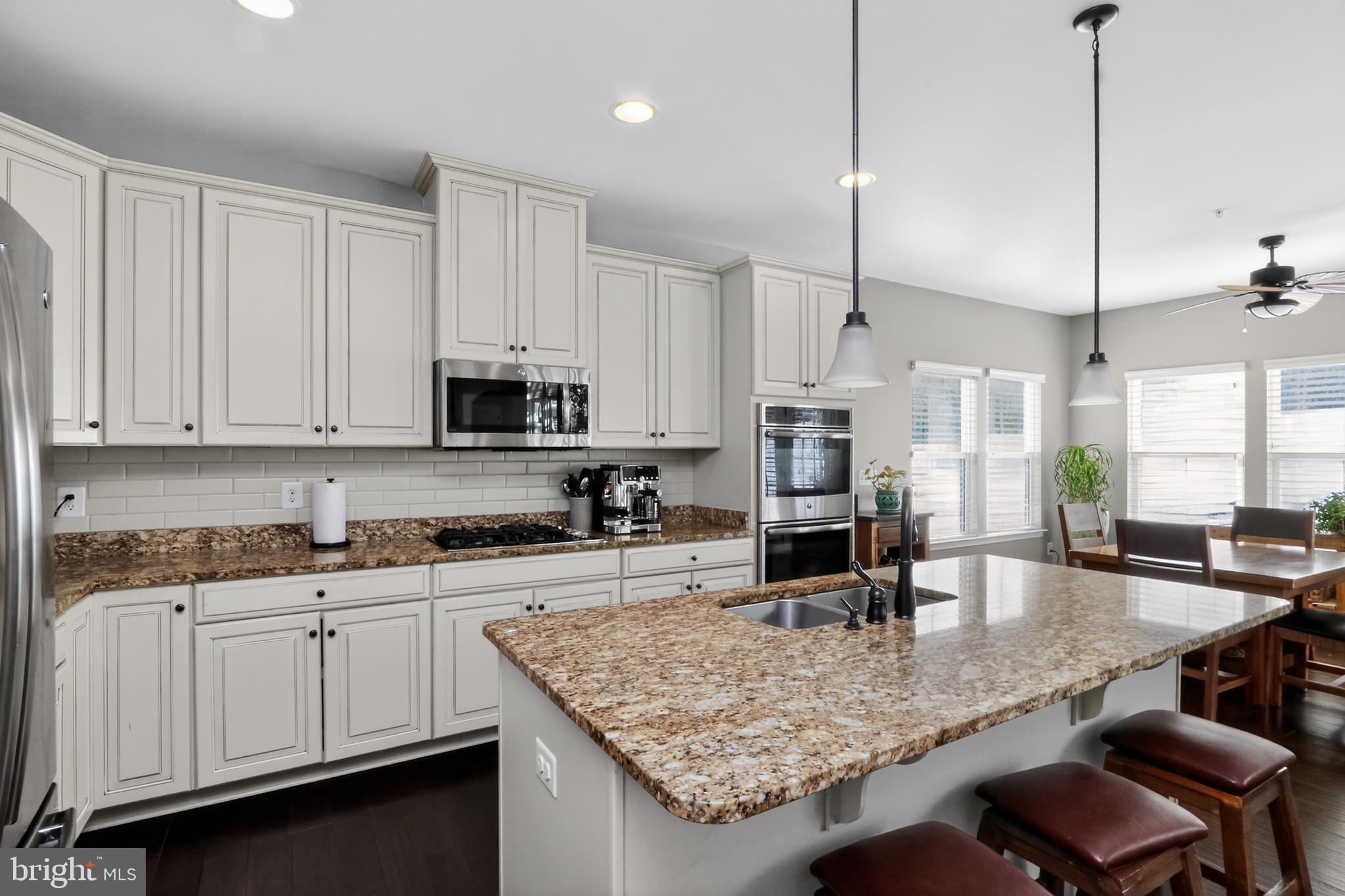 17518 Spring Cress Drive Dumfries, VA 22026 - Photo 4 of 37 a kitchen with granite countertop a sink a counter space appliances and cabinets