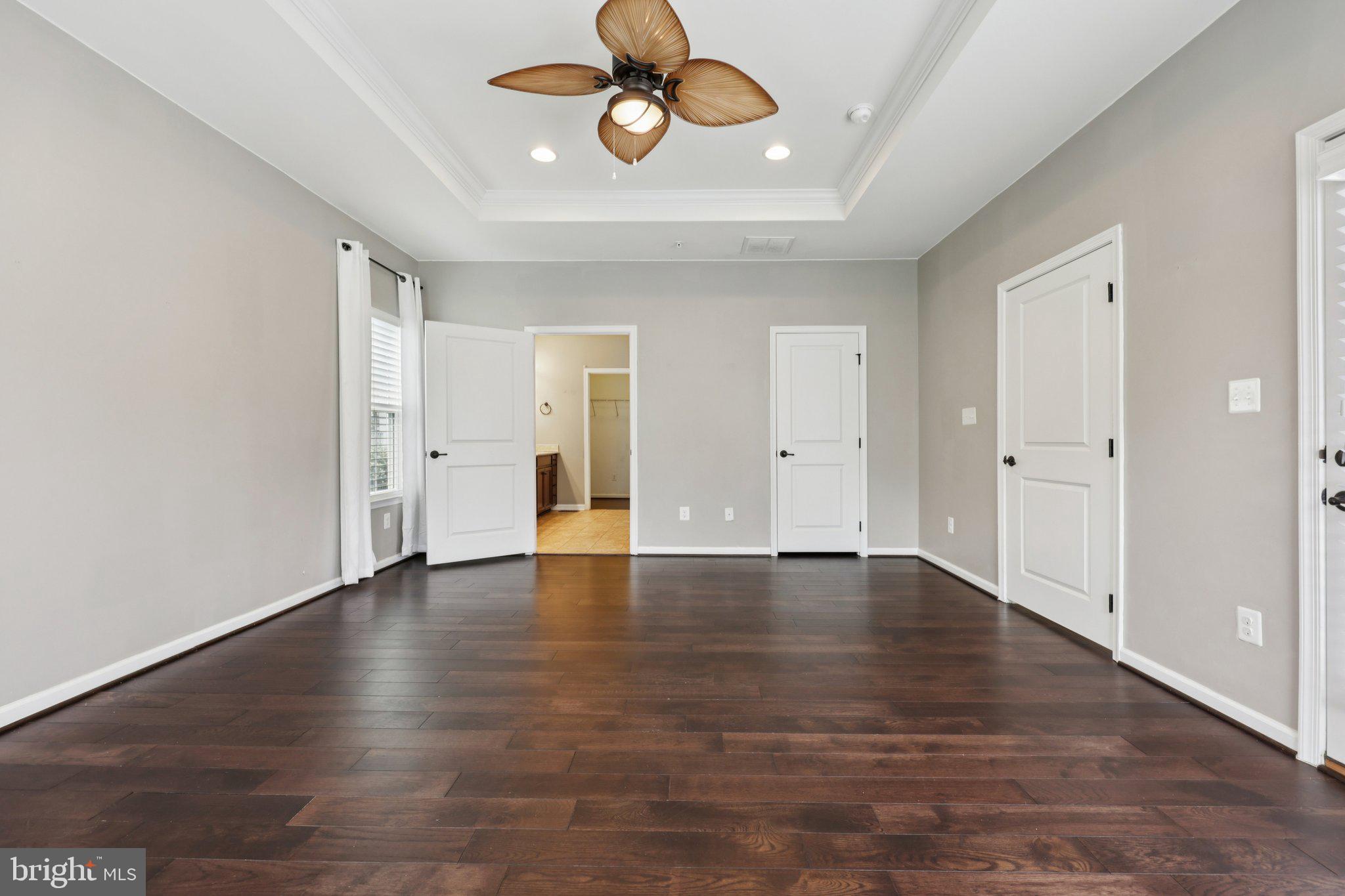 17518 Spring Cress Drive Dumfries, VA 22026 - Photo 48 of 89 an empty room with wooden floor and windows