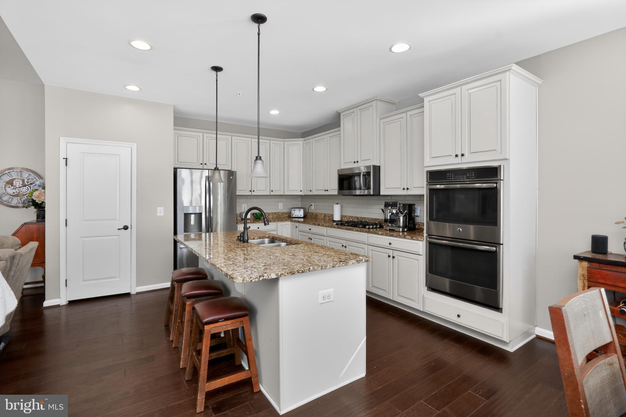 17518 Spring Cress Drive Dumfries, VA 22026 - Photo 6 of 37 a kitchen with stainless steel appliances granite countertop a refrigerator a stove a sink and a microwave