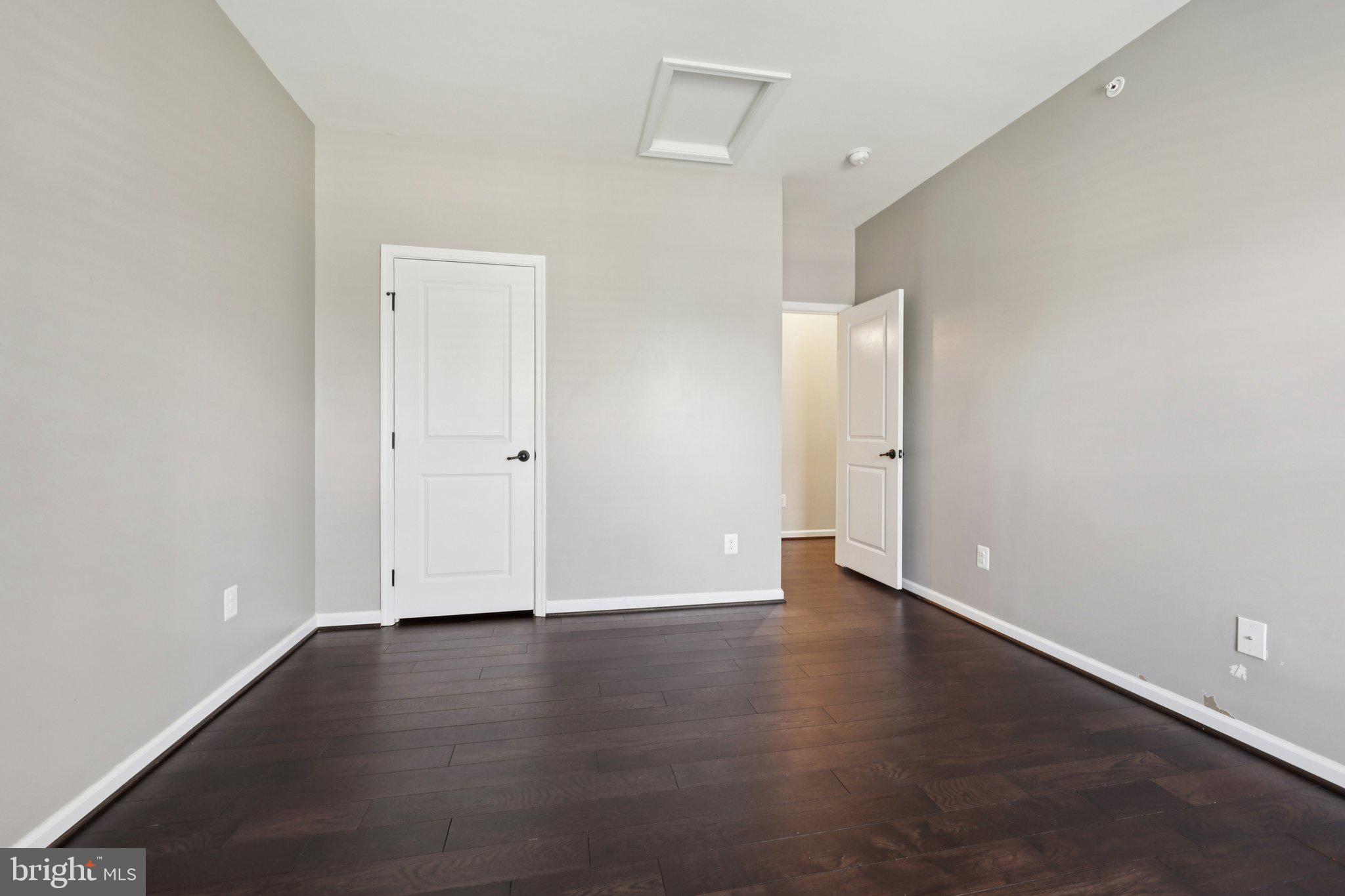17518 Spring Cress Drive Dumfries, VA 22026 - Photo 61 of 89 an empty room with wooden floor and white wall