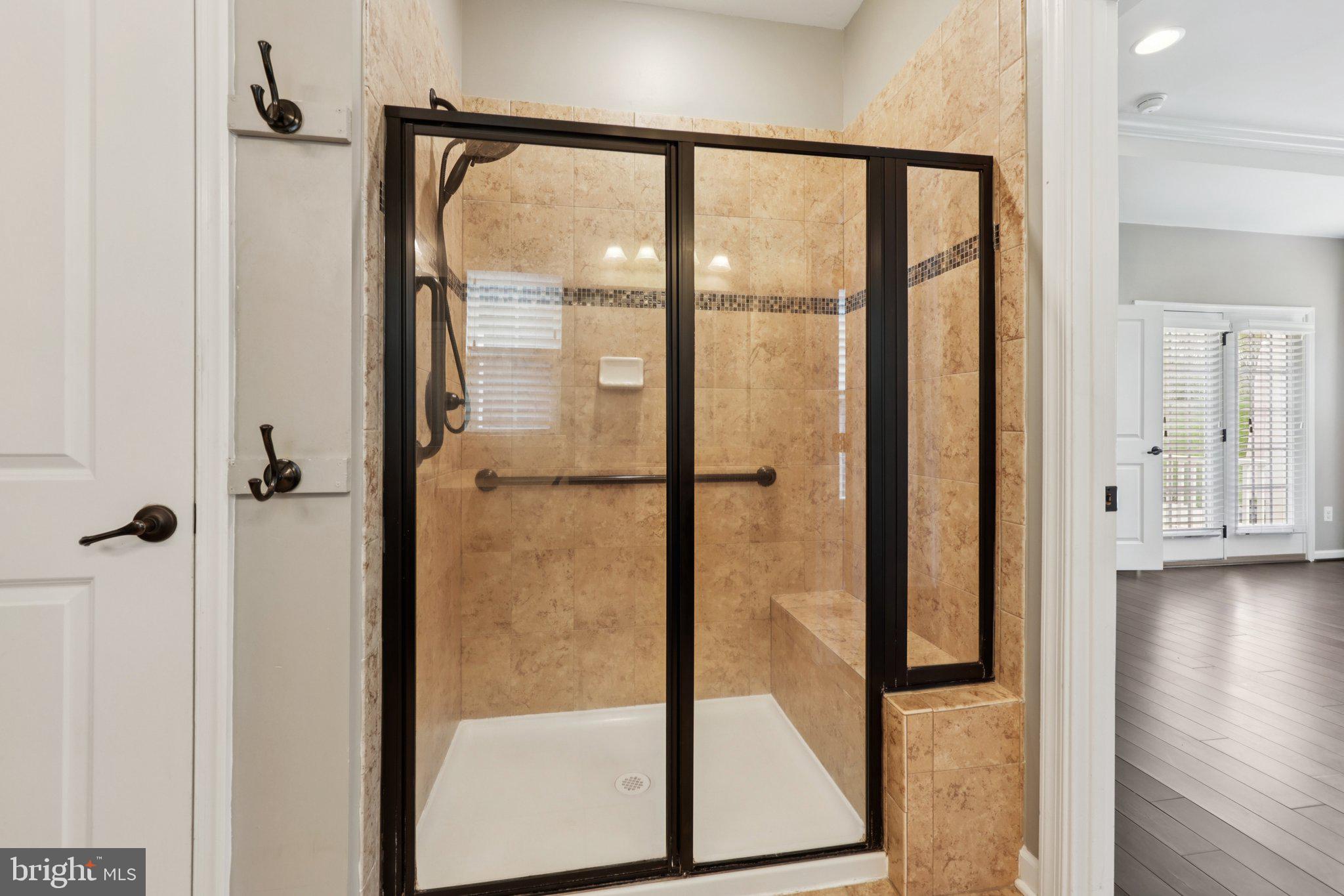 17518 Spring Cress Drive Dumfries, VA 22026 - Photo 64 of 89 a bathroom with a glass shower door