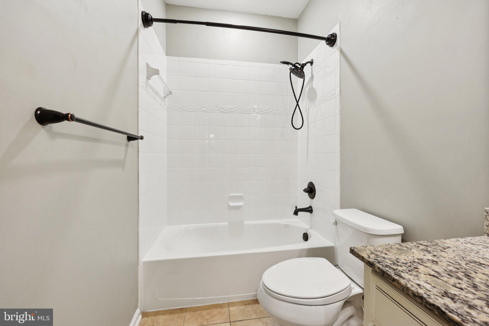 17518 Spring Cress Drive Dumfries, VA 22026 - Photo 67 of 89 a bathroom with a granite countertop bathtub shower sink vanity and toilet