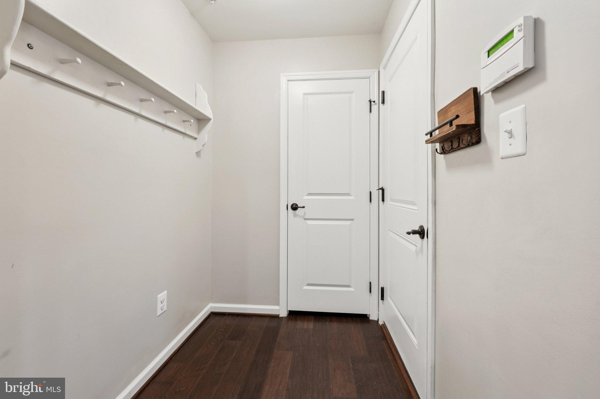 17518 Spring Cress Drive Dumfries, VA 22026 - Photo 71 of 89 a view of a hallway with wooden floor and staircase