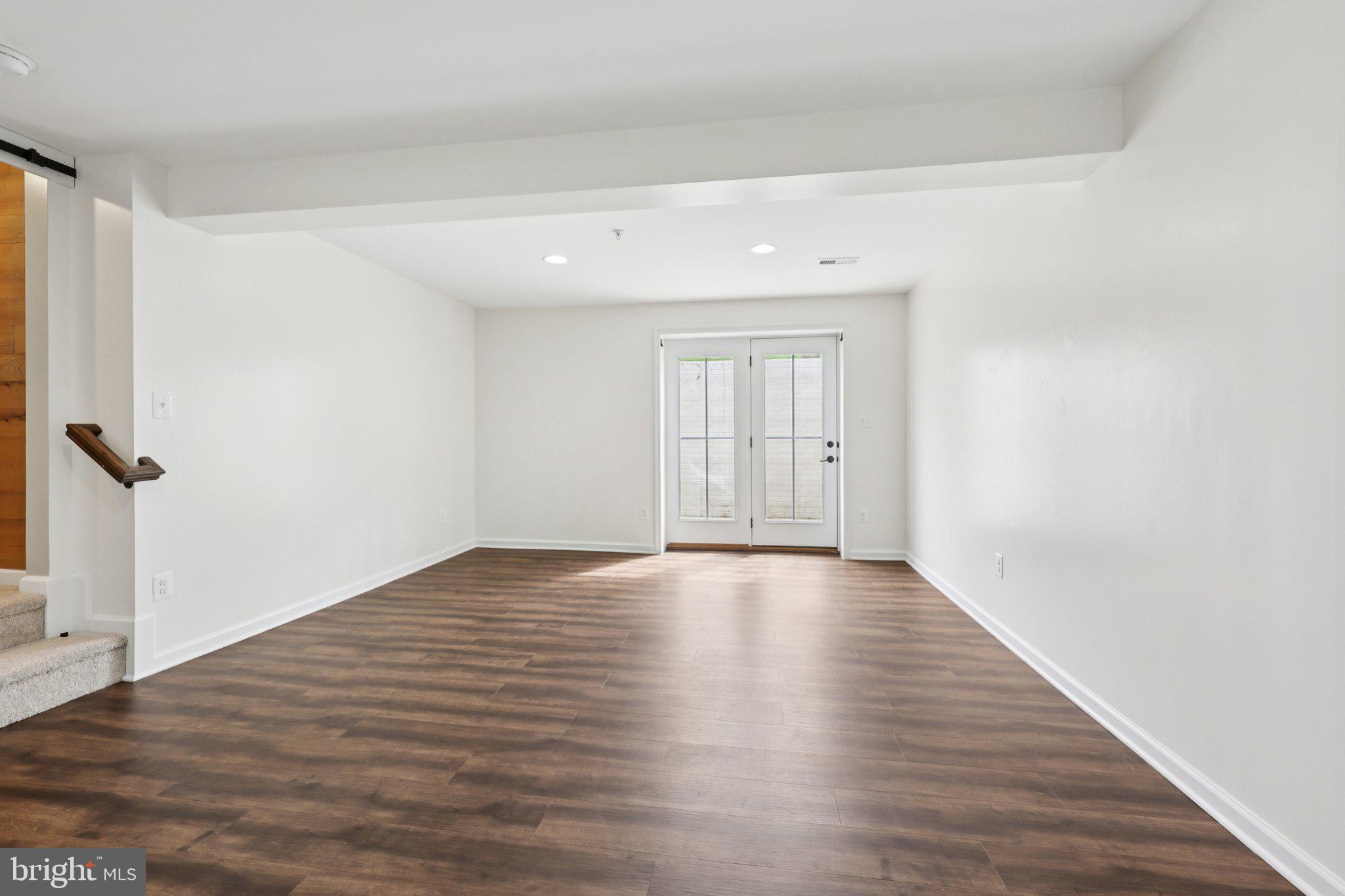 17518 Spring Cress Drive Dumfries, VA 22026 - Photo 81 of 89 a view of an empty room with wooden floor and a window