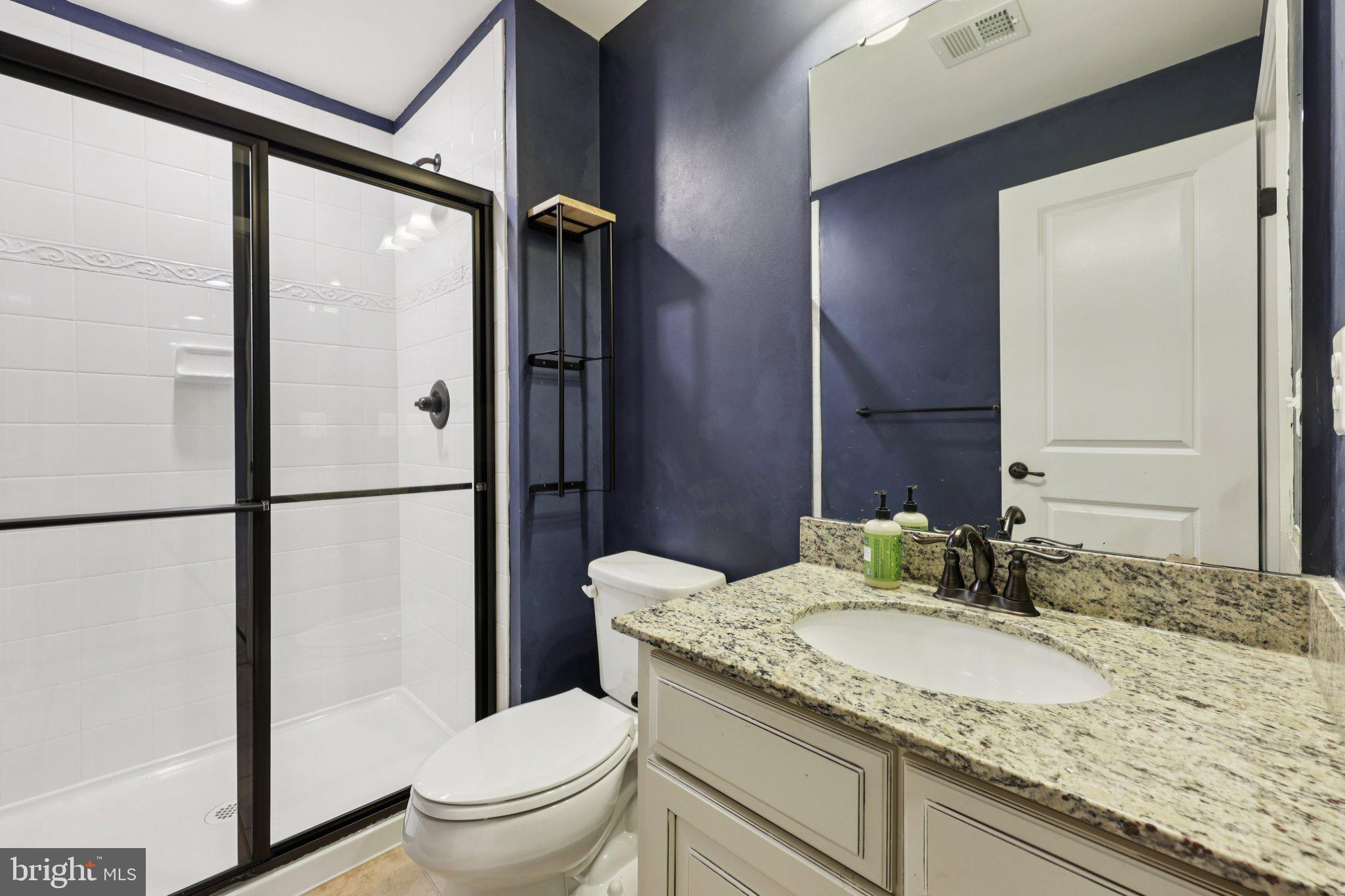 17518 Spring Cress Drive Dumfries, VA 22026 - Photo 83 of 89 a bathroom with a granite countertop sink toilet and shower