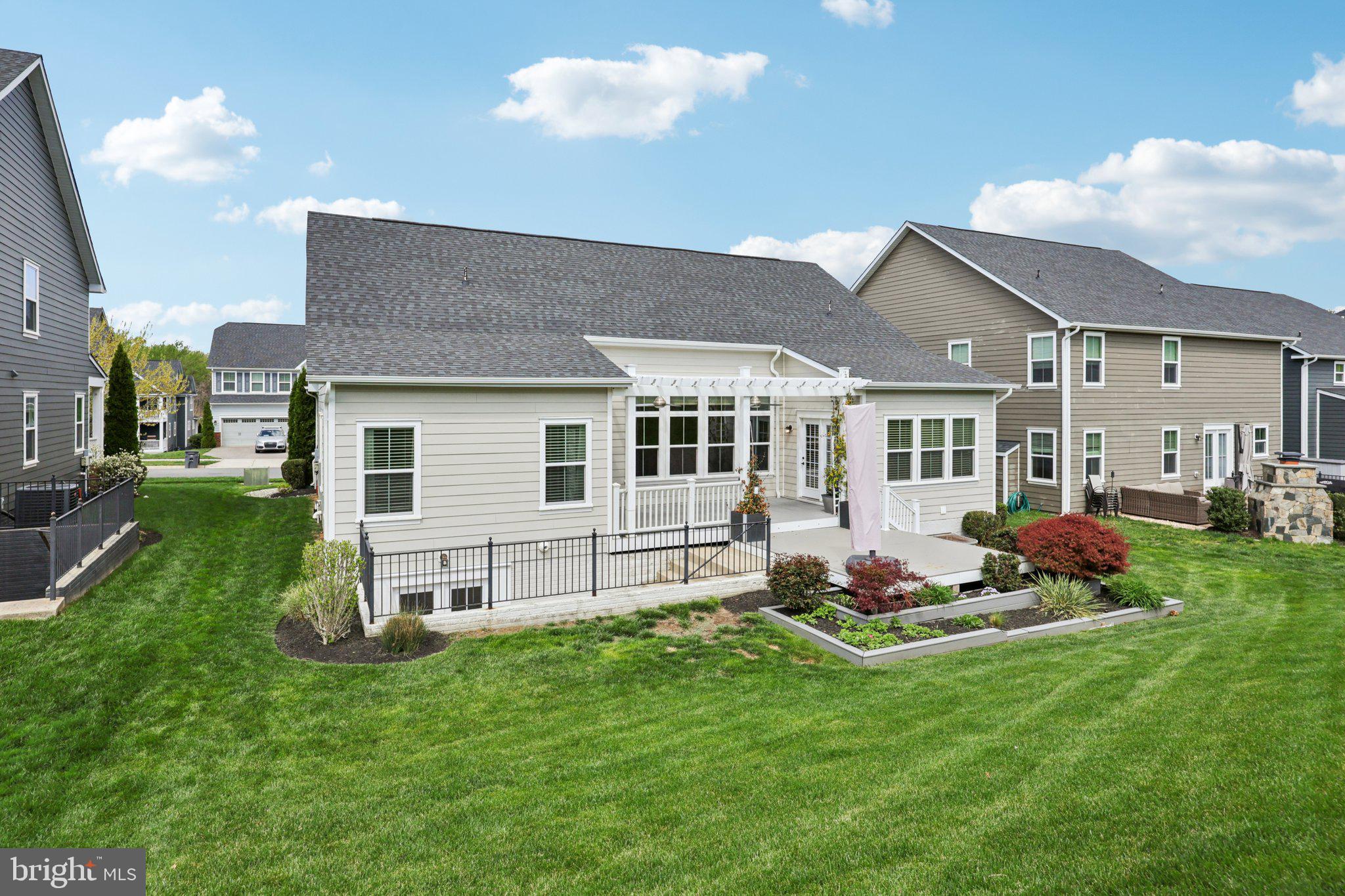 17518 Spring Cress Drive Dumfries, VA 22026 - Photo 87 of 89 a front view of a house with a garden and chairs