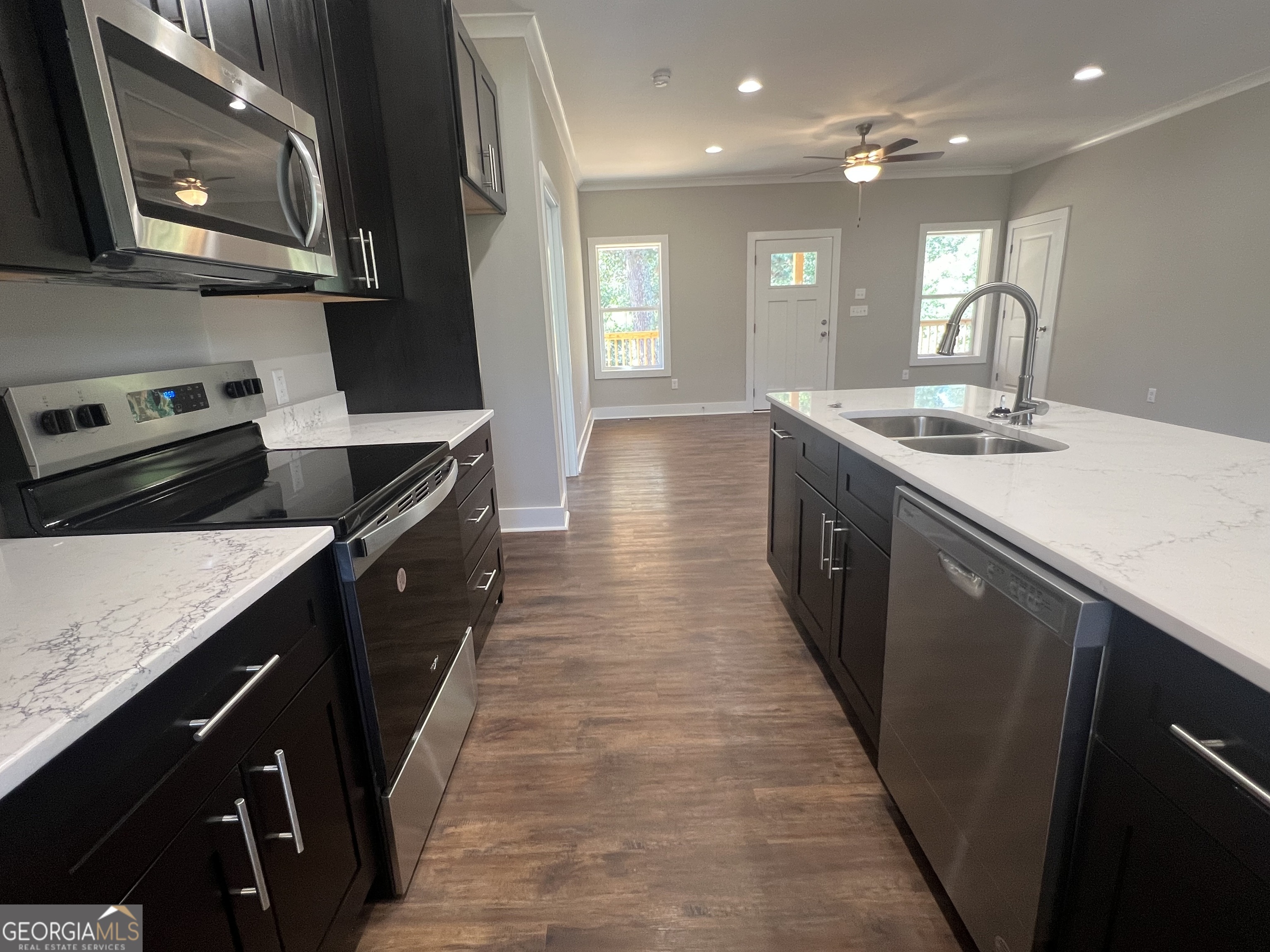 195 Cedar Road Covington, GA 30016 - Photo 6 of 19 a kitchen with stainless steel appliances granite countertop a sink a stove top oven and a refrigerator