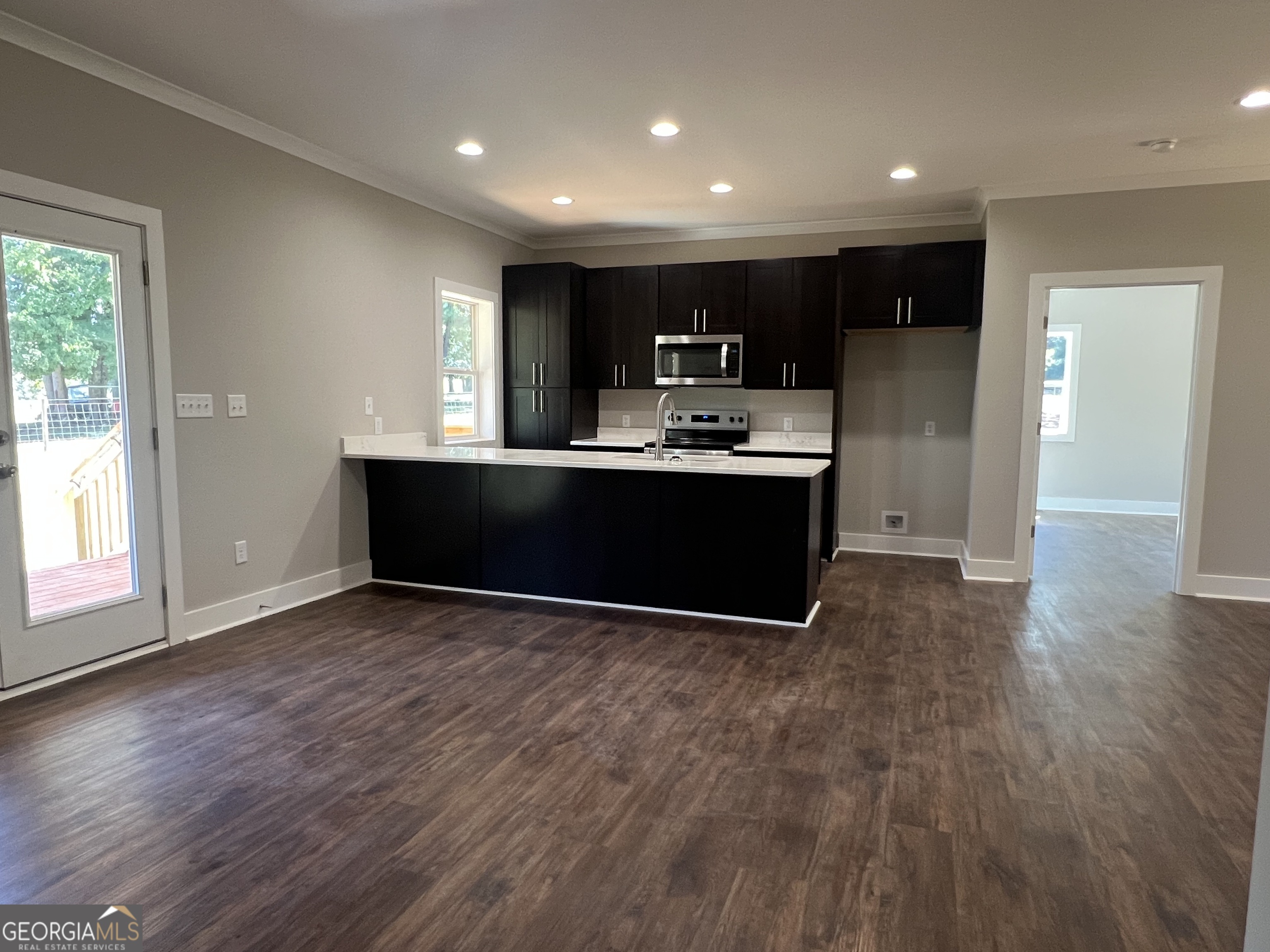 195 Cedar Road Covington, GA 30016 - Photo 7 of 19 a view of kitchen with kitchen island wooden floors and stainless steel appliances