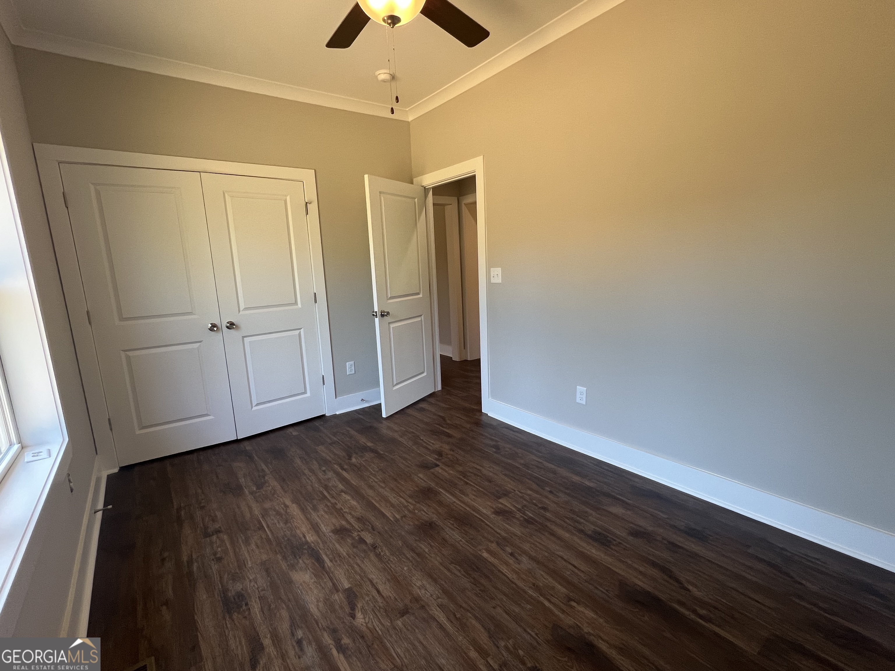195 Cedar Road Covington, GA 30016 - Photo 8 of 19 a view of an empty room with wooden floor and a window