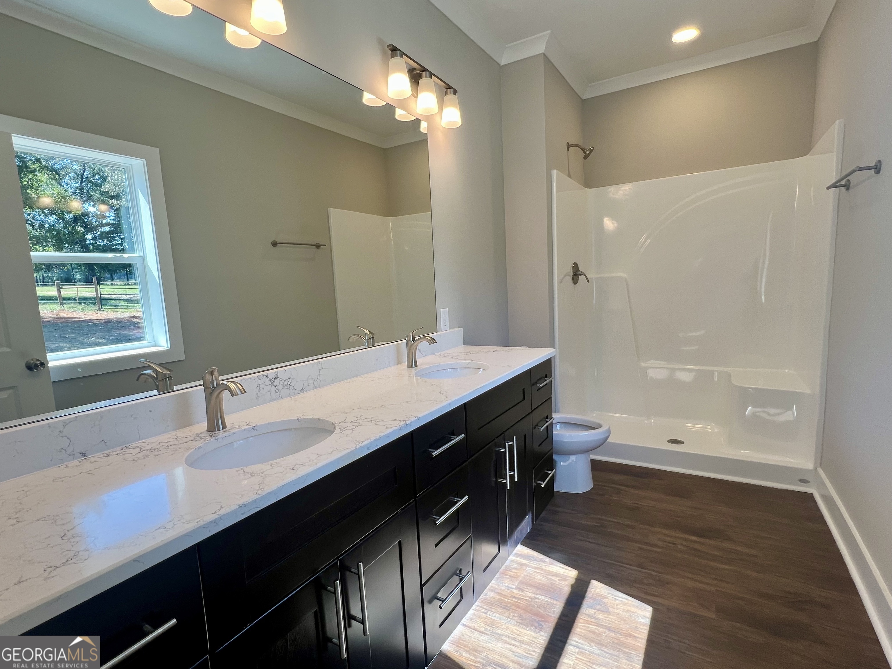 195 Cedar Road Covington, GA 30016 - Photo 10 of 19 a bathroom with a double vanity sink a toilet and a mirror