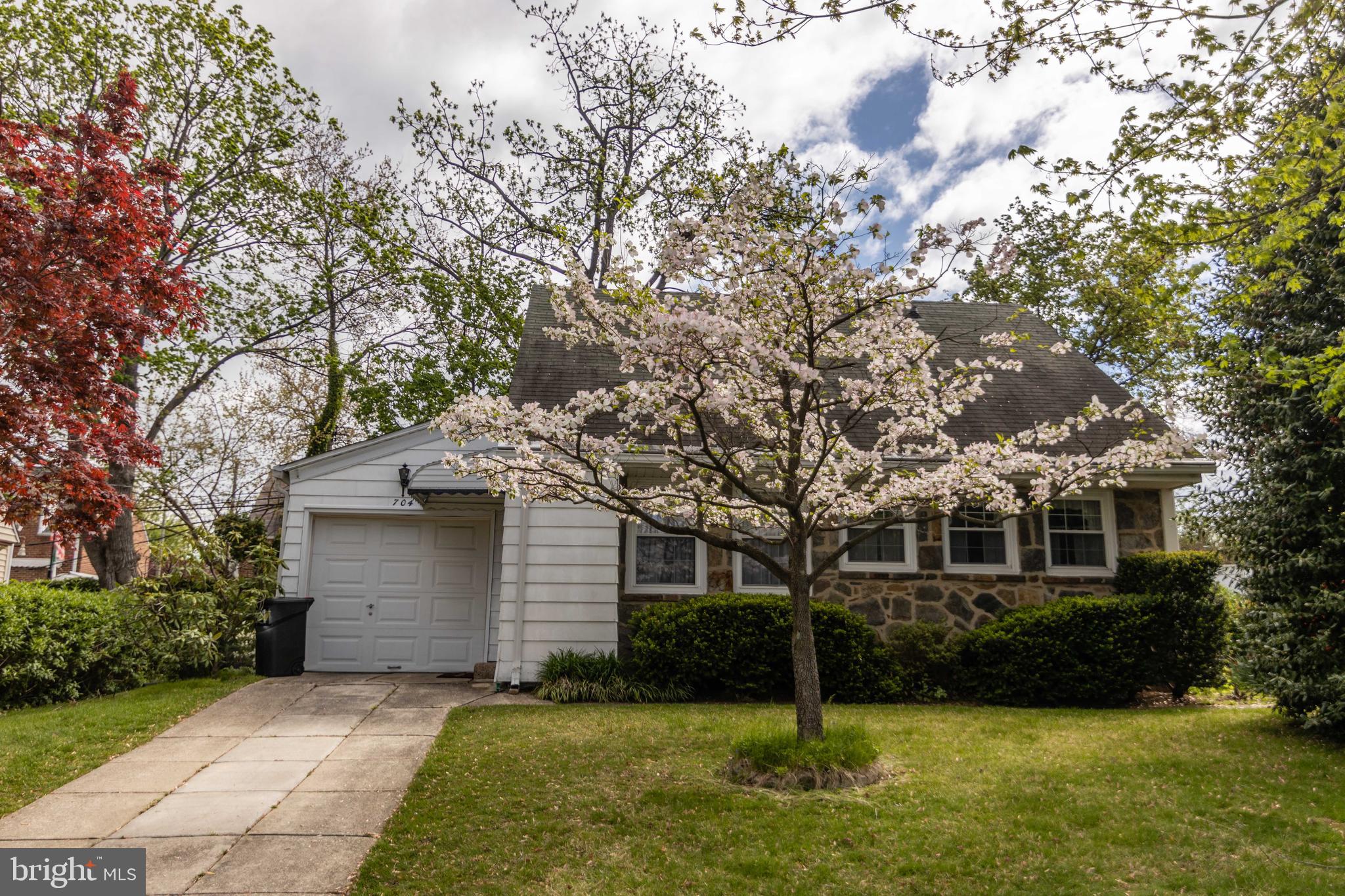 704 Hood Road Swarthmore, PA 19081 - Photo 1 of 34 a front view of a house with a yard and garage