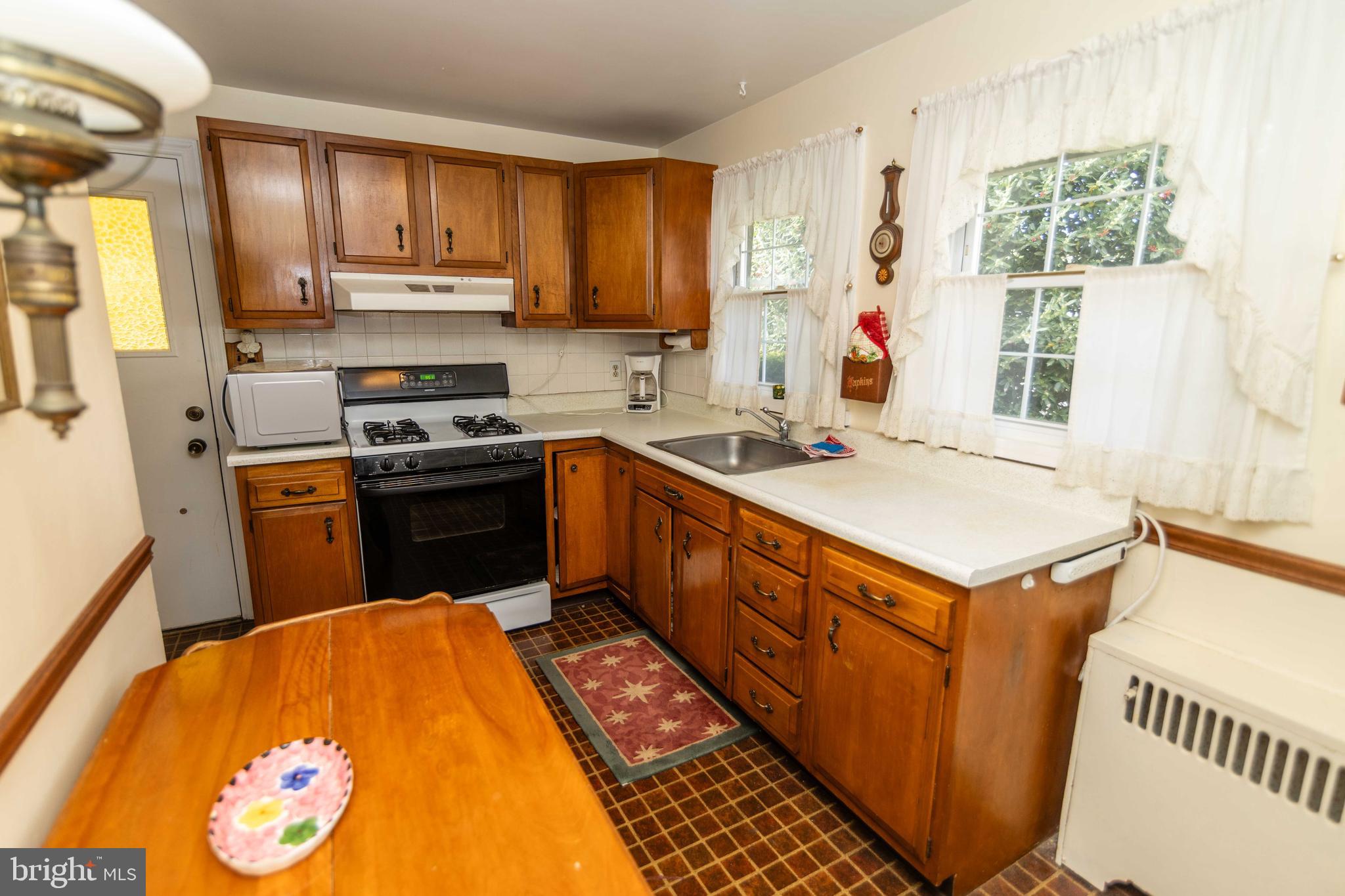 704 Hood Road Swarthmore, PA 19081 - Photo 12 of 34 a kitchen with a stove a sink a refrigerator and a microwave