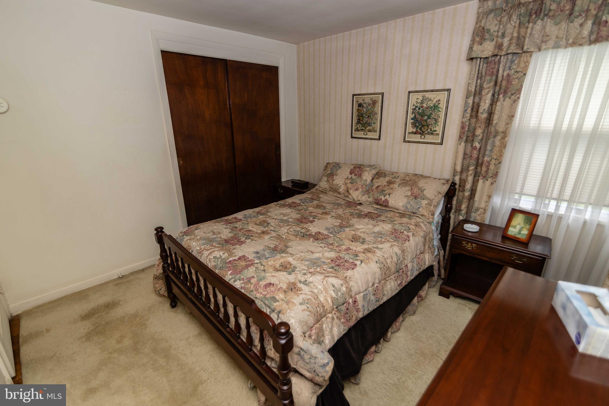 704 Hood Road Swarthmore, PA 19081 - Photo 14 of 34 a bed sitting in a bedroom next to a window