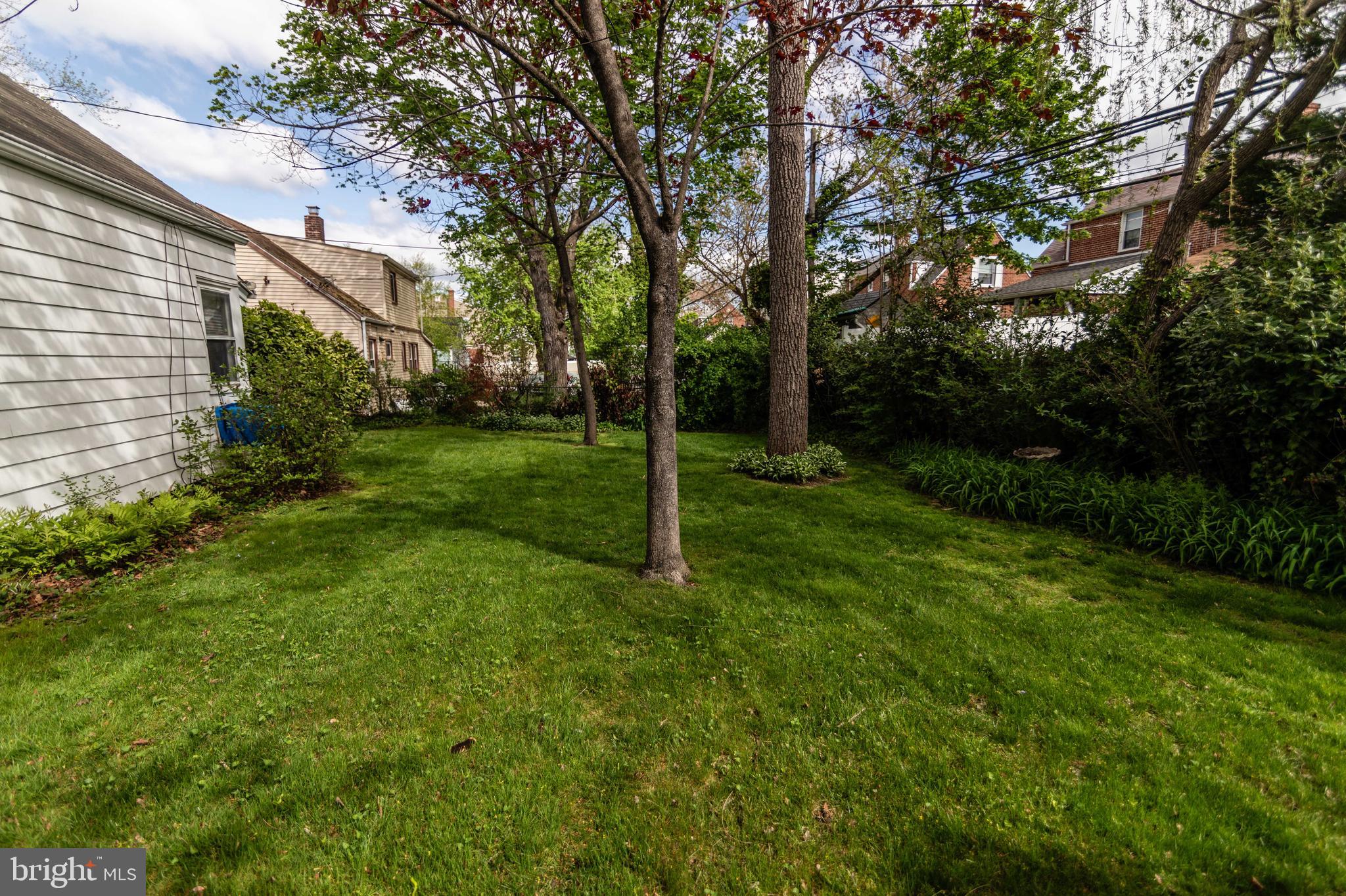 704 Hood Road Swarthmore, PA 19081 - Photo 27 of 34 a view of a backyard with a garden