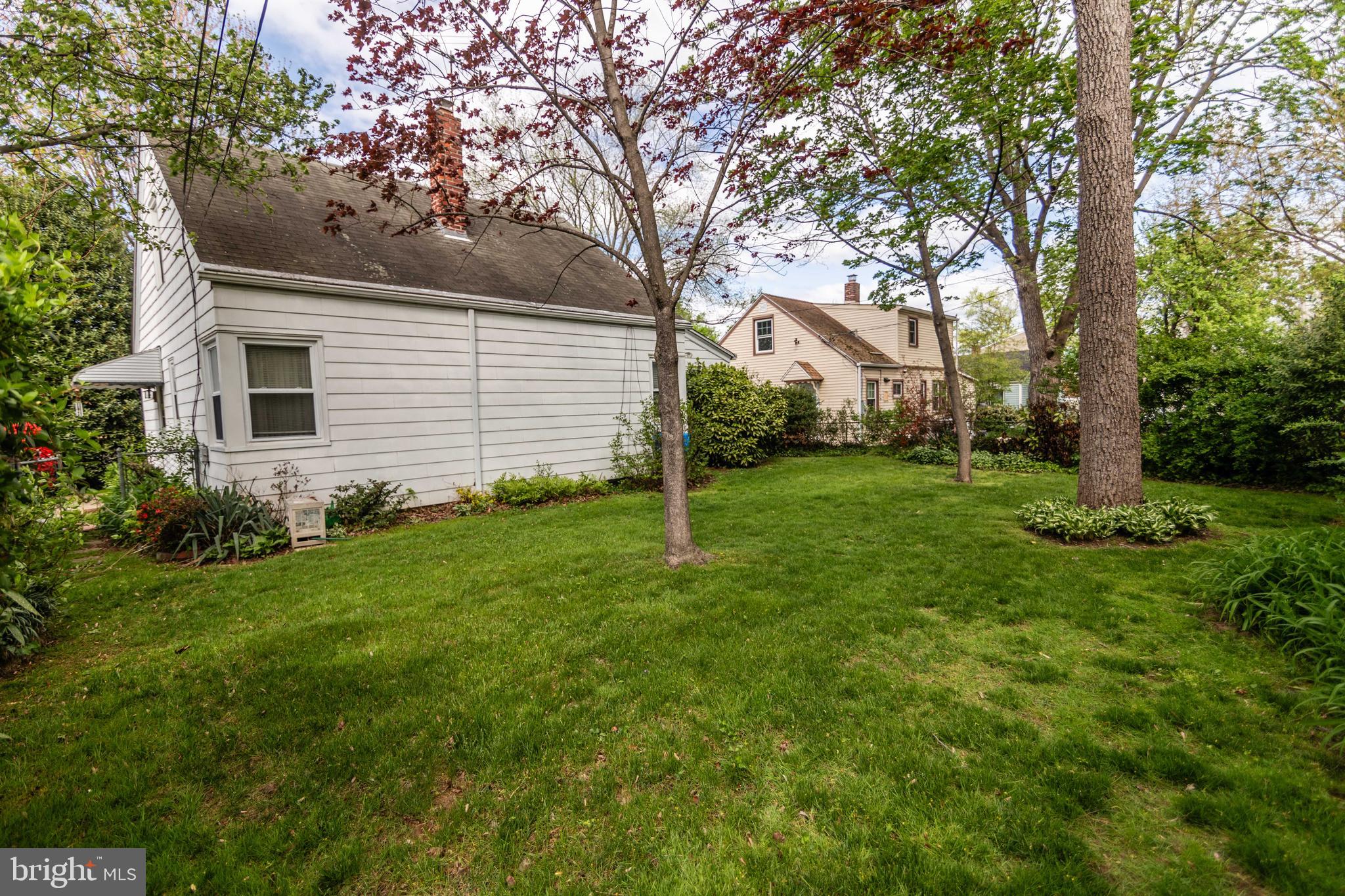 704 Hood Road Swarthmore, PA 19081 - Photo 29 of 34 a backyard of a house with plants and large tree