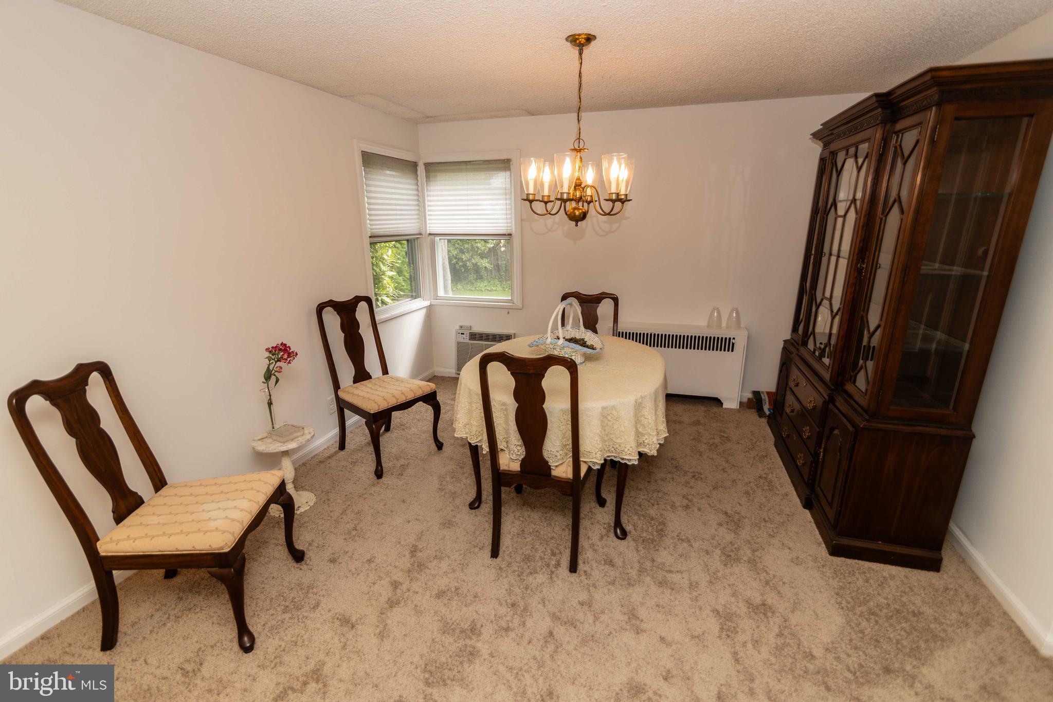 704 Hood Road Swarthmore, PA 19081 - Photo 5 of 34 a view of a dining room with furniture a chandelier and window