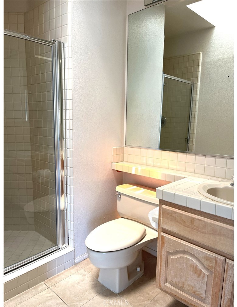 23 San Raphael Dana Point, CA 92629 - Photo 19 of 24 a bathroom with a toilet a sink and shower